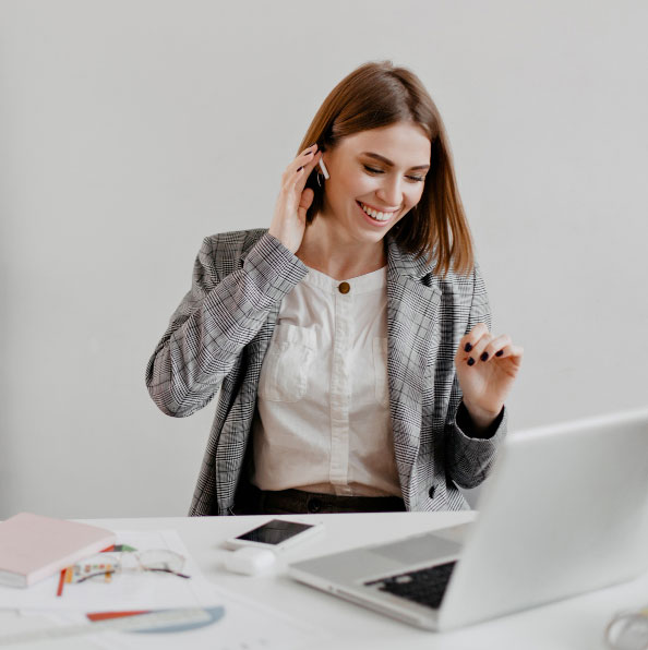 sweet-short-haired-business-lady-laughs-while-listening-to-music-on-headphones-portrait-of-woman-in-office-clothes-sitting-in-workplace sweet-short-haired-business-lady-laughs-while-listening-to-music-on-headphones-portrait-of-woman-in-office-clothes-sitting-in-workplace