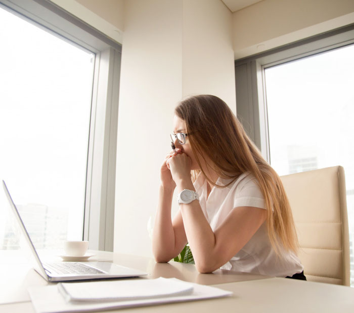 worried-thoughtful-businesswoman-thinking-hard-of-problem-looking-at-laptop